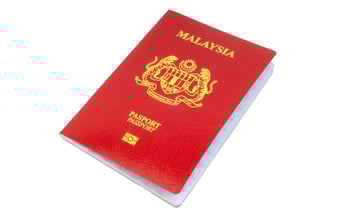 Red Malaysian passport on white