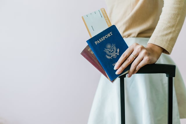 A Close Up Of A Girl Holding Passports And A Boarding Pass