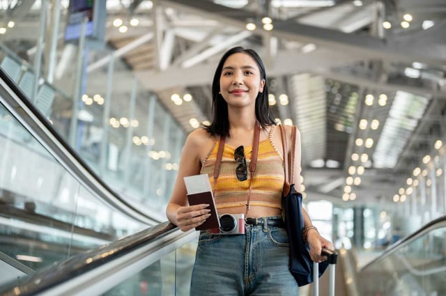 Happy Asian Female Tourist Passenger With A Passport
