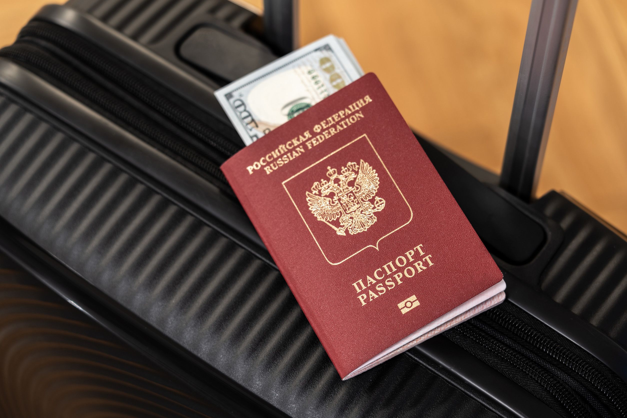 a suitcase with a passport and money lying on it before going on a trip