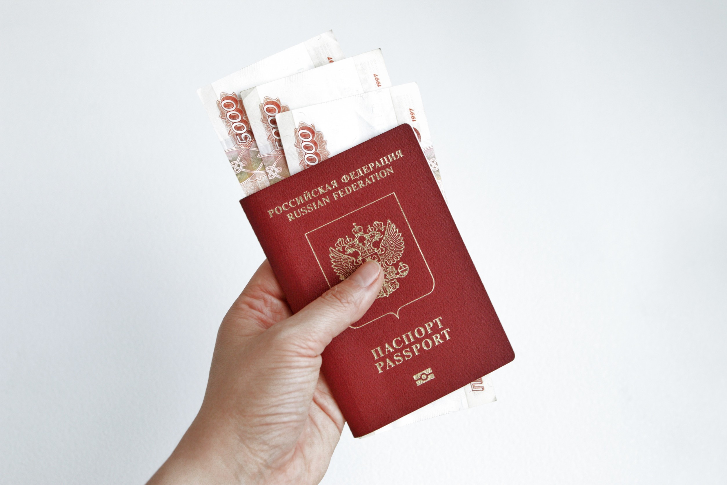 hand holding russian passport