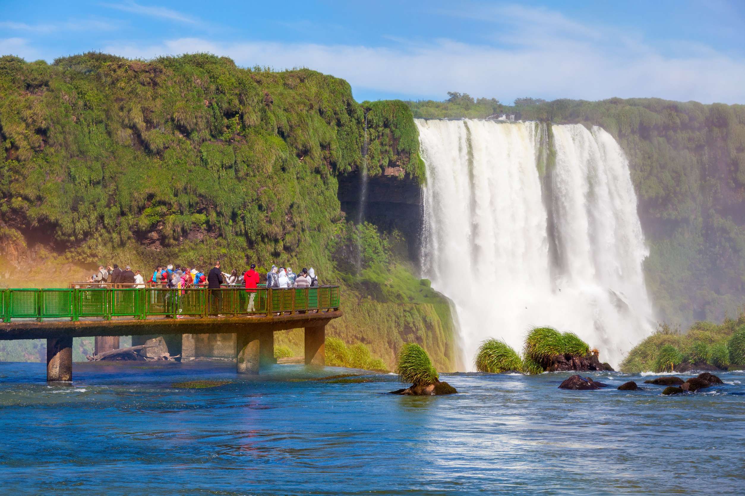 tourists near the iguazu falls waterfalls of the iguazu river on the border
